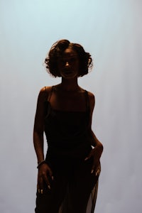 a woman in a black dress posing for a photo