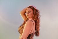 a woman in a brown dress posing for a photo