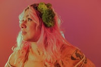 a woman with pink hair and tattoos