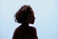 a silhouette of a woman against a blue background